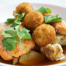 Seared Salmon Finished with Fresh Herbs, Wild Mushroom Broth, Served with Roasted Root Vegetables and Arancini
